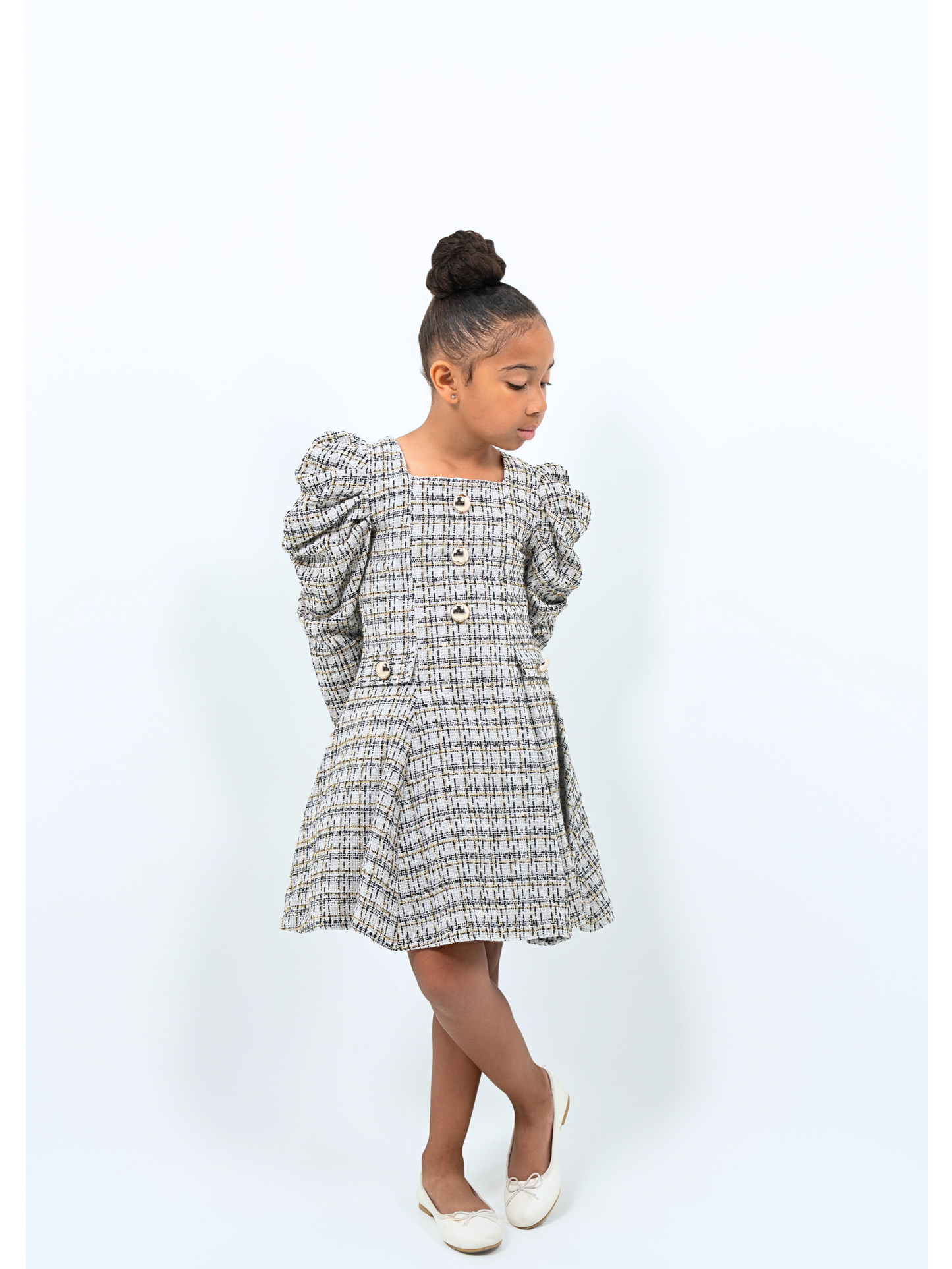 Girl wearing tweed puff sleeve coat dress with gold buttons, ideal for holidays or special events