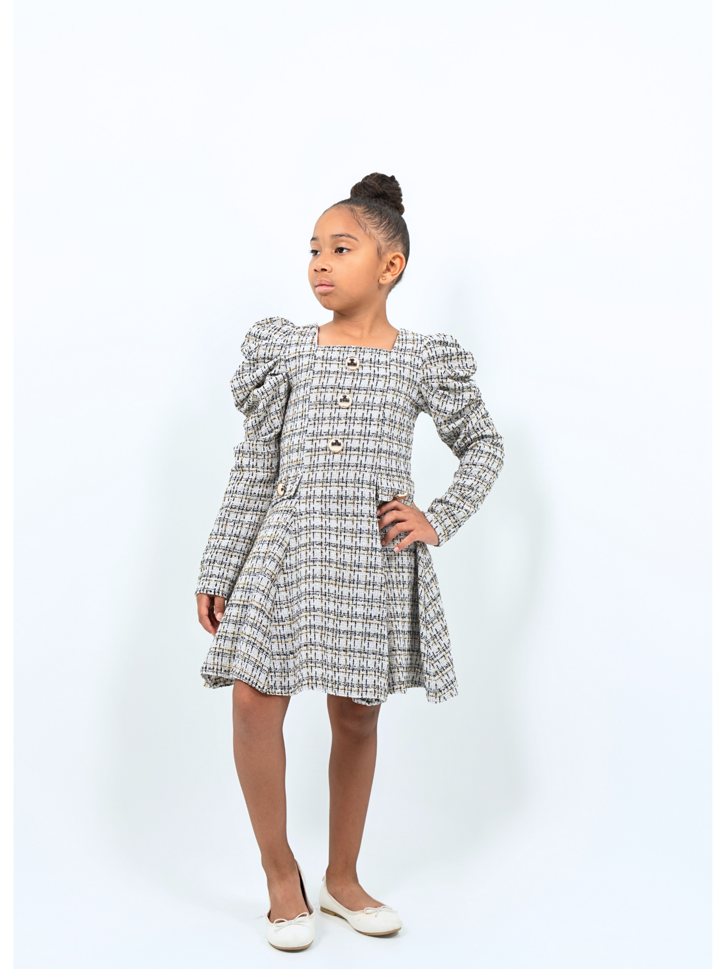 Girl wearing tweed puff sleeve coat dress with gold buttons, ideal for holidays or special events
