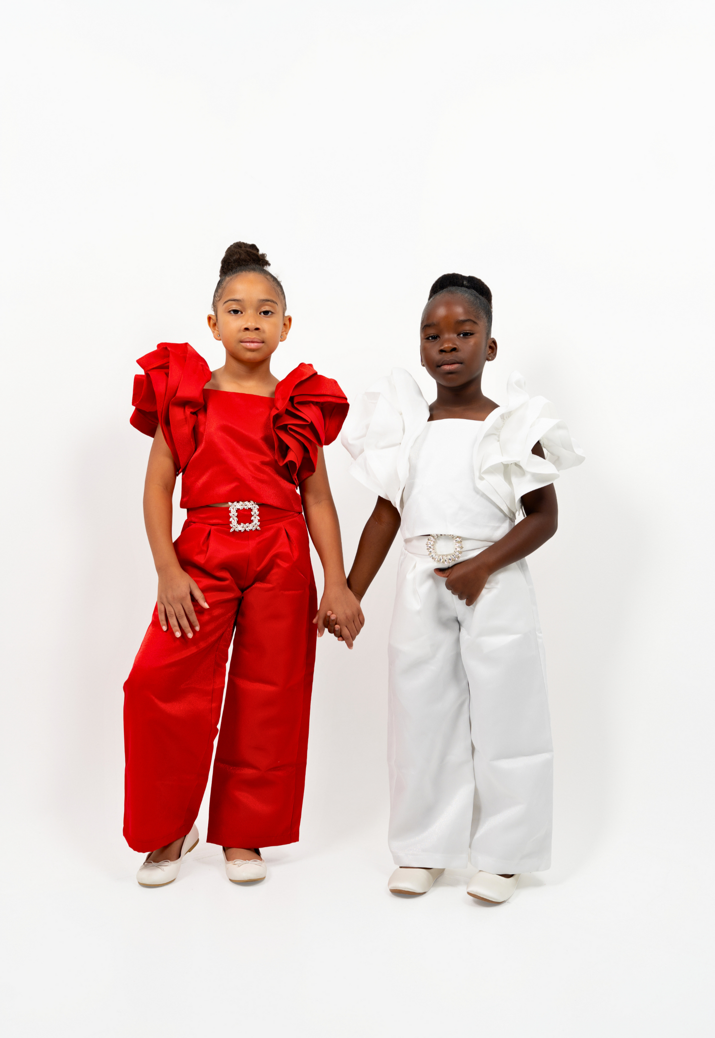Girl in red shimmer pantsuit with ruffled sleeves and rhinestone belt – festive occasion outfit for toddler and girls