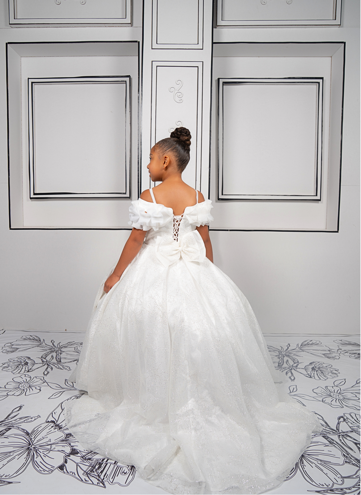 This elegant white ball gown is perfect for flower girls and little brides. With sparkly tulle and a dreamy silhouette, it’s a fairytale favorite.