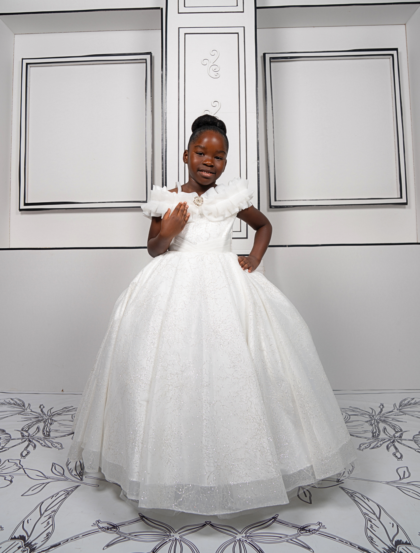 This elegant white ball gown is perfect for flower girls and little brides. With sparkly tulle and a dreamy silhouette, it’s a fairytale favorite.