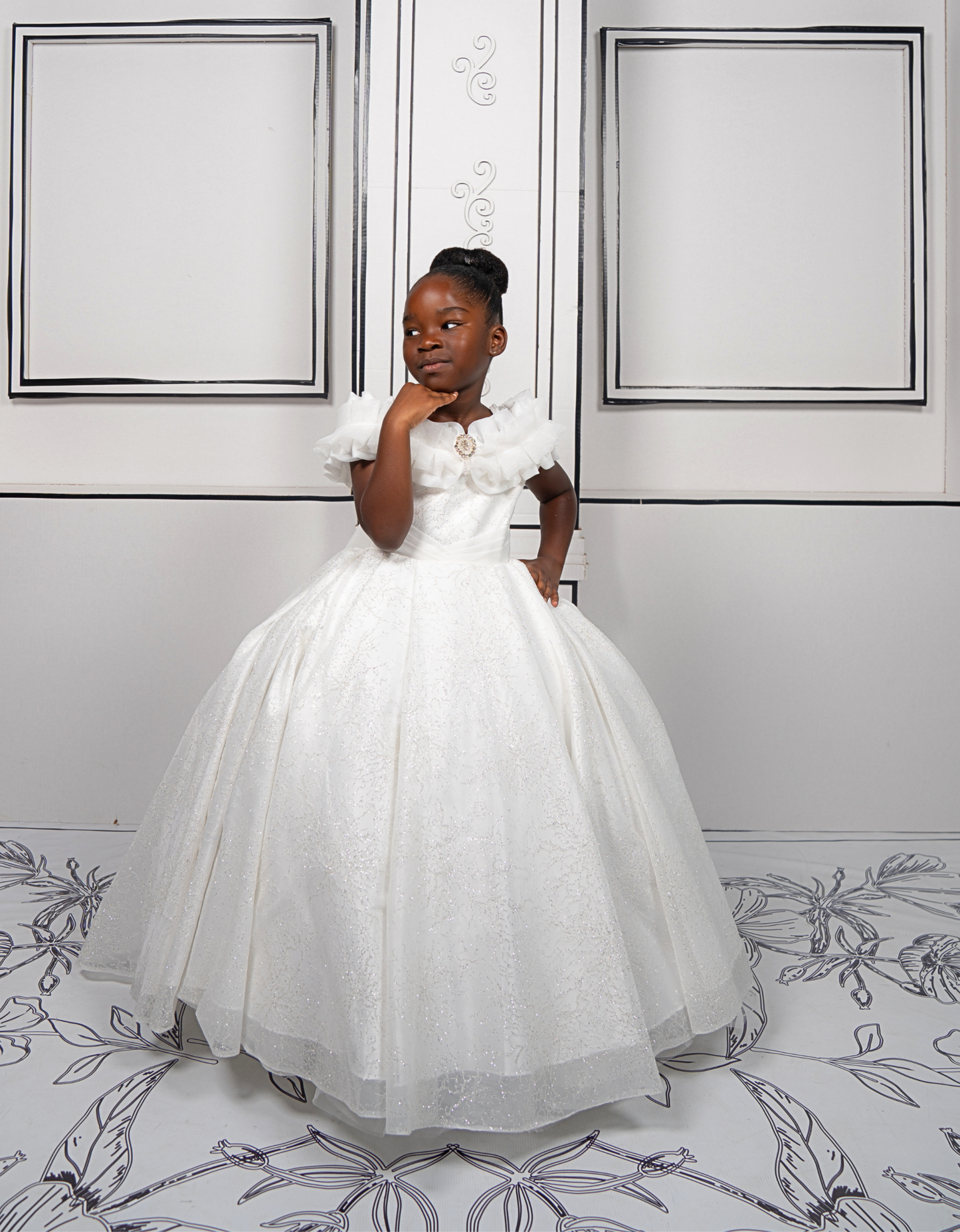 This elegant white ball gown is perfect for flower girls and little brides. With sparkly tulle and a dreamy silhouette, it’s a fairytale favorite.
