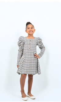 Girl wearing tweed puff sleeve coat dress with gold buttons, ideal for holidays or special events
