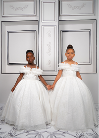 This elegant white ball gown is perfect for flower girls and little brides. With sparkly tulle and a dreamy silhouette, it’s a fairytale favorite.