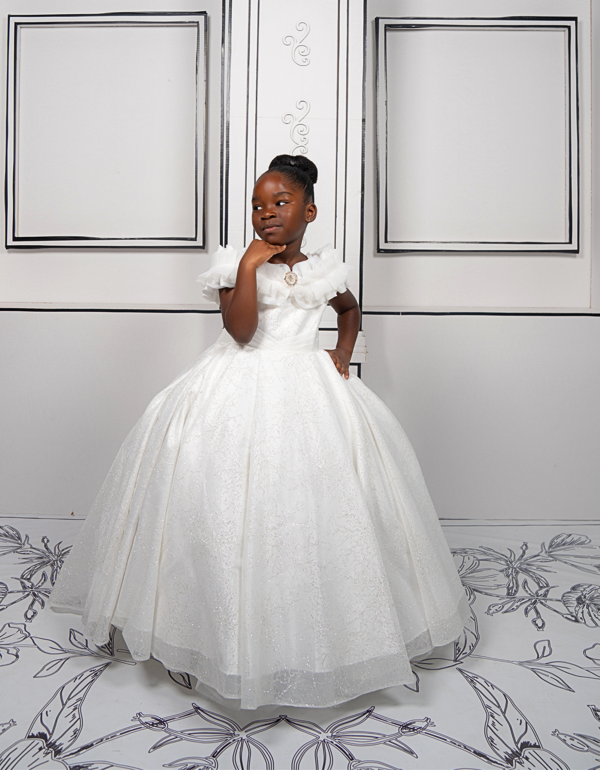 This elegant white ball gown is perfect for flower girls and little brides. With sparkly tulle and a dreamy silhouette, it’s a fairytale favorite.