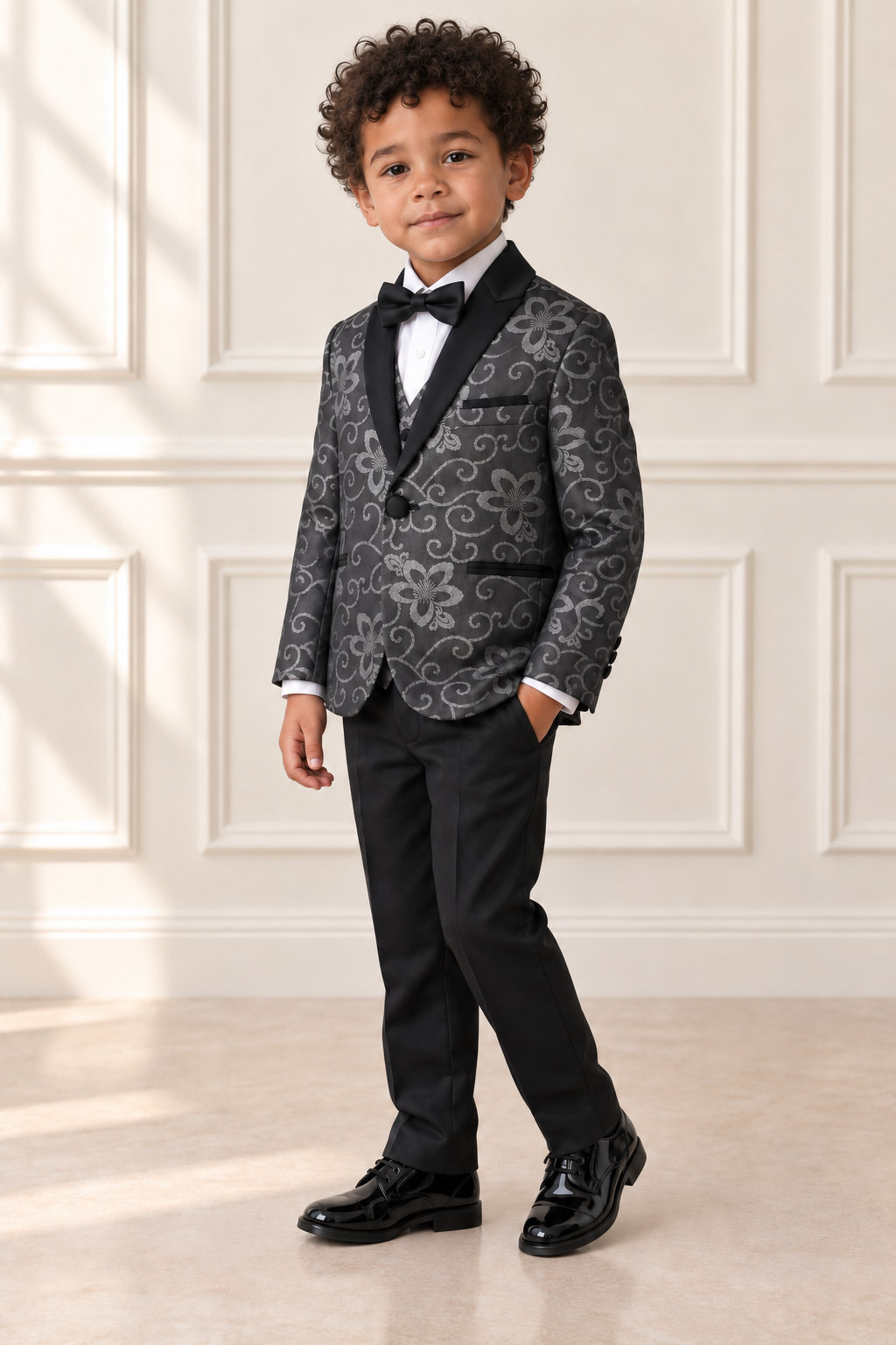 Mixed-race boy wearing black and silver floral suit, angled view