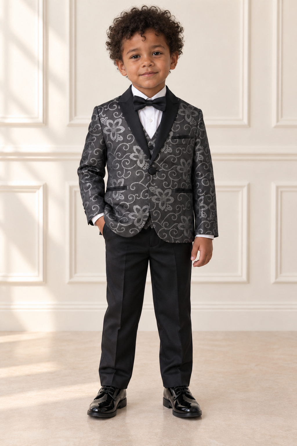 Mixed-race boy wearing black and silver floral suit, front view