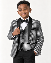 Black boy wearing black and white shimmery five-piece tuxedo, waistcoat detail