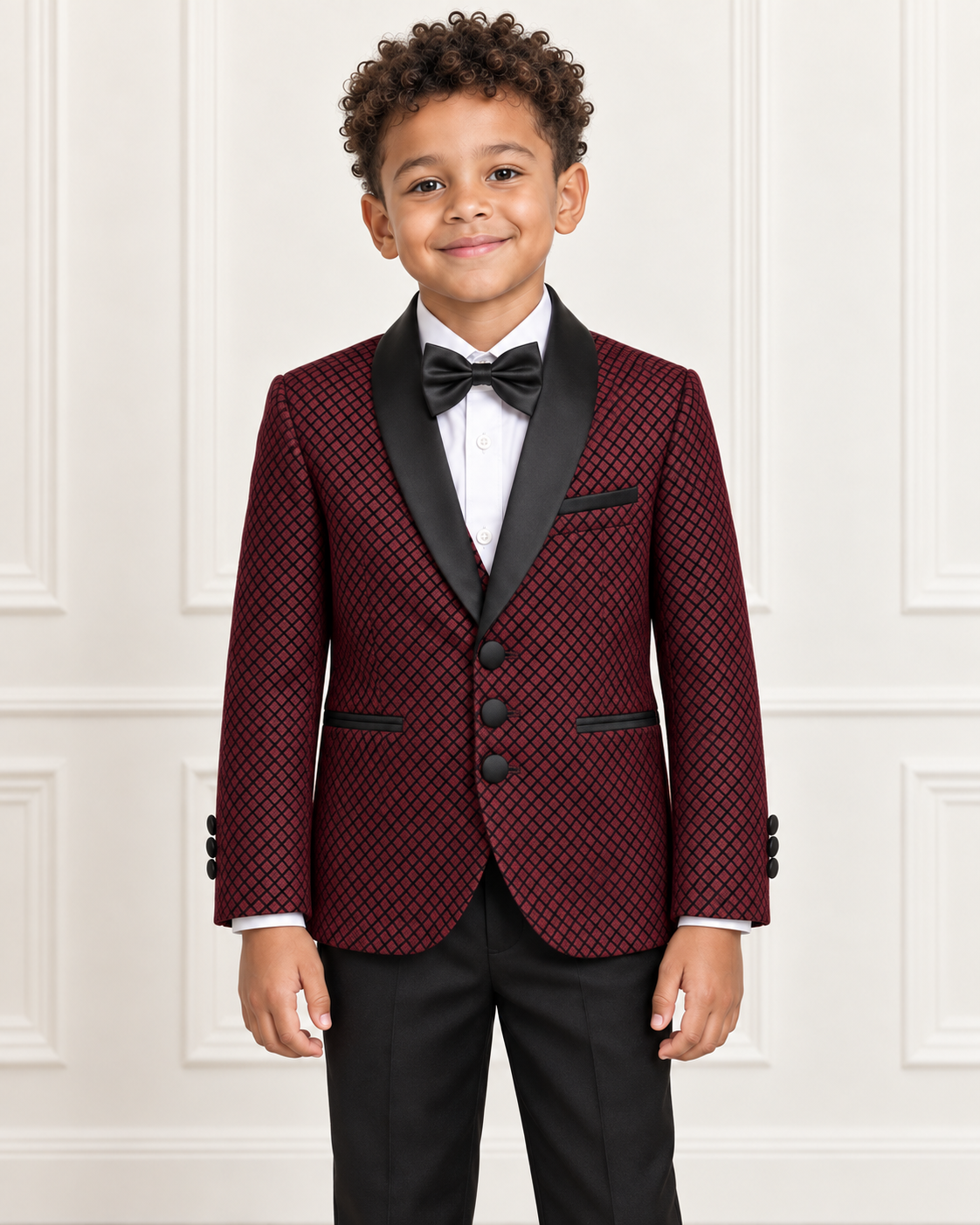 Detail view of mixed-race boy wearing the burgundy shimmery five-piece tuxedo suit