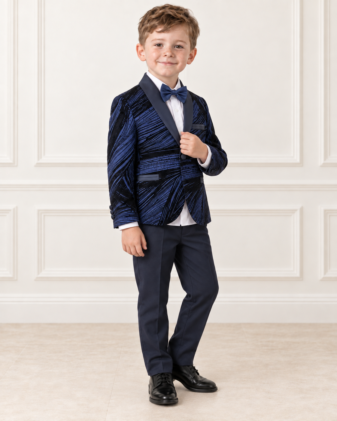 White boy wearing navy blue shimmery tuxedo, angled view